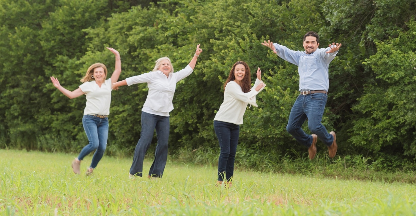 Denton dentist and dental team members laughing outdoors