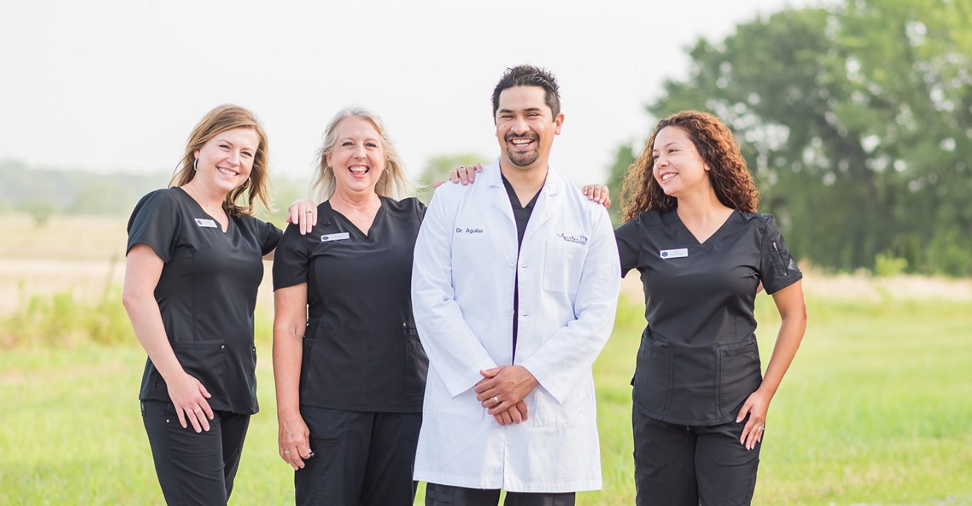 Denton dentist and dental team jumping outdoors