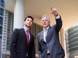 A senior businessman pointing at something in the distance