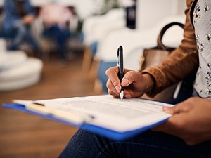 Patient filling out paperwork in lobby