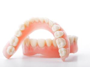 Closeup of full dentures in Denton on a white background