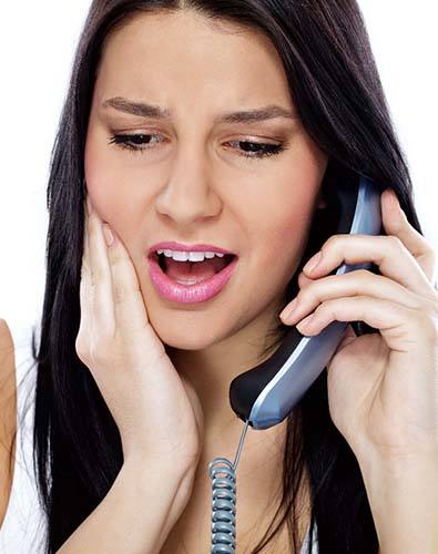 Pained woman calling her Denton emergency dentist