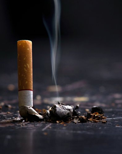 Snuffed cigarette still smolders