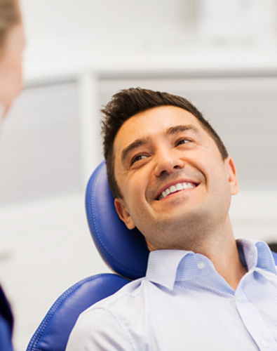 Man smiles at dentist