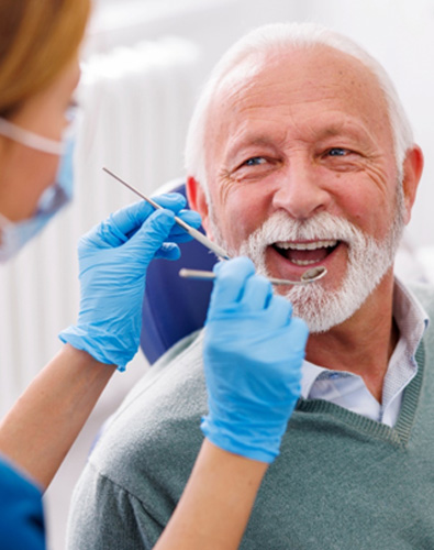 Man smiles at dentist