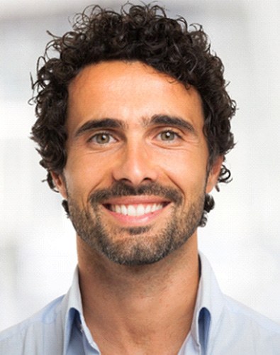Man with beard smiling with dental implants in Denton, TX
