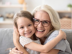 older woman smiling with young girl