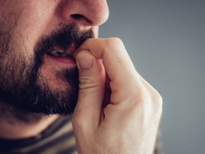 man biting his fingernails