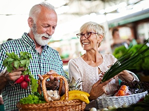 A senior couple buying healthy foods to eat