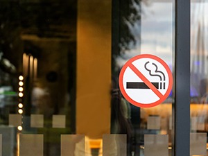 A ‘No Smoking’ sticker on a glass door