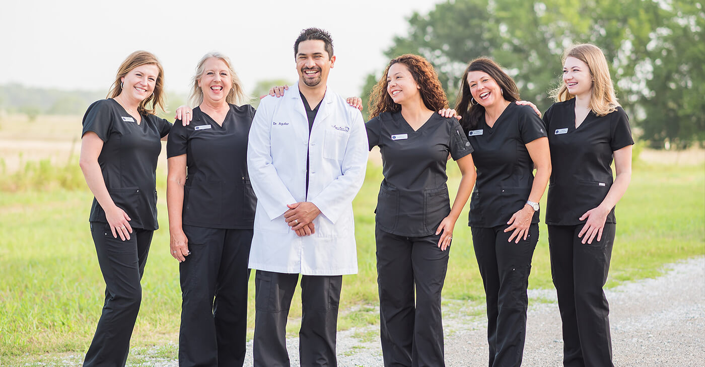 Denton dentist and dental team members laughing outdoors