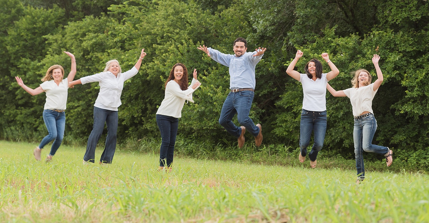 Denton dentist and dental team jumping outdoors