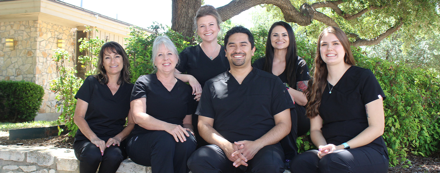 Smiling dentist and dental team in Denton outdoors