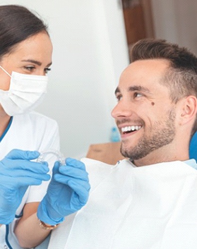 dentist in Denton, TX showing a patient how Invisalign works