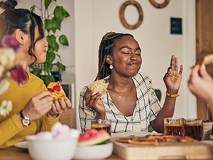Friends enjoying meal together in kitchen