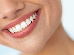 Closeup of patient with straight teeth smiling
