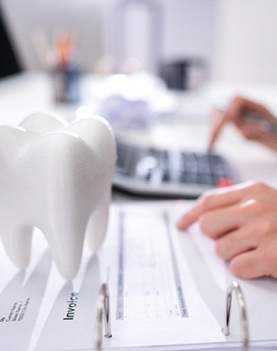 patient calculating cost of Invisalign in Denton