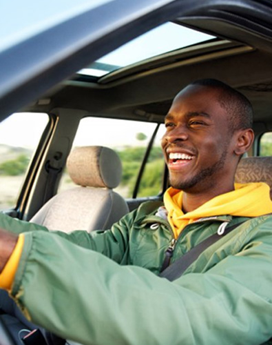 Man smiles while driving
