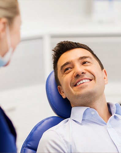 Man smiling after receiving tooth-colored filling