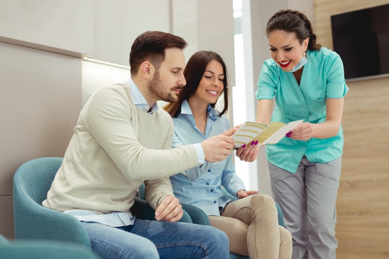 Dentist explaining dental insurance to patients